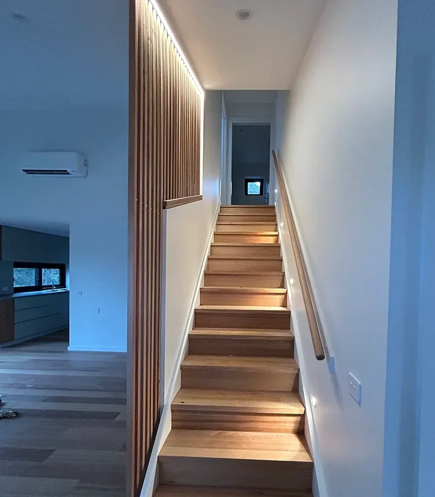 A Wooden Staircase With Recessed Lighting — Straight up Building Projects in Belconnen, ACT