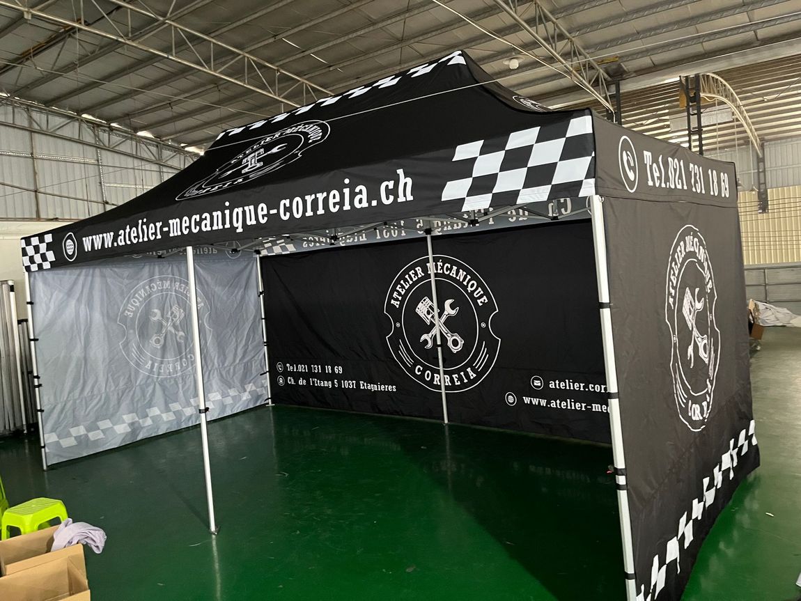 Black-and-white checkered event tent with open entrance inside a large indoor venue