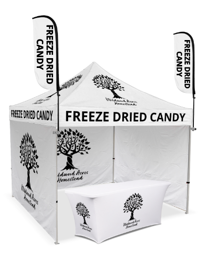 White freeze-dried candy vendor booth with tree logo and black lettering on canopy and panels.