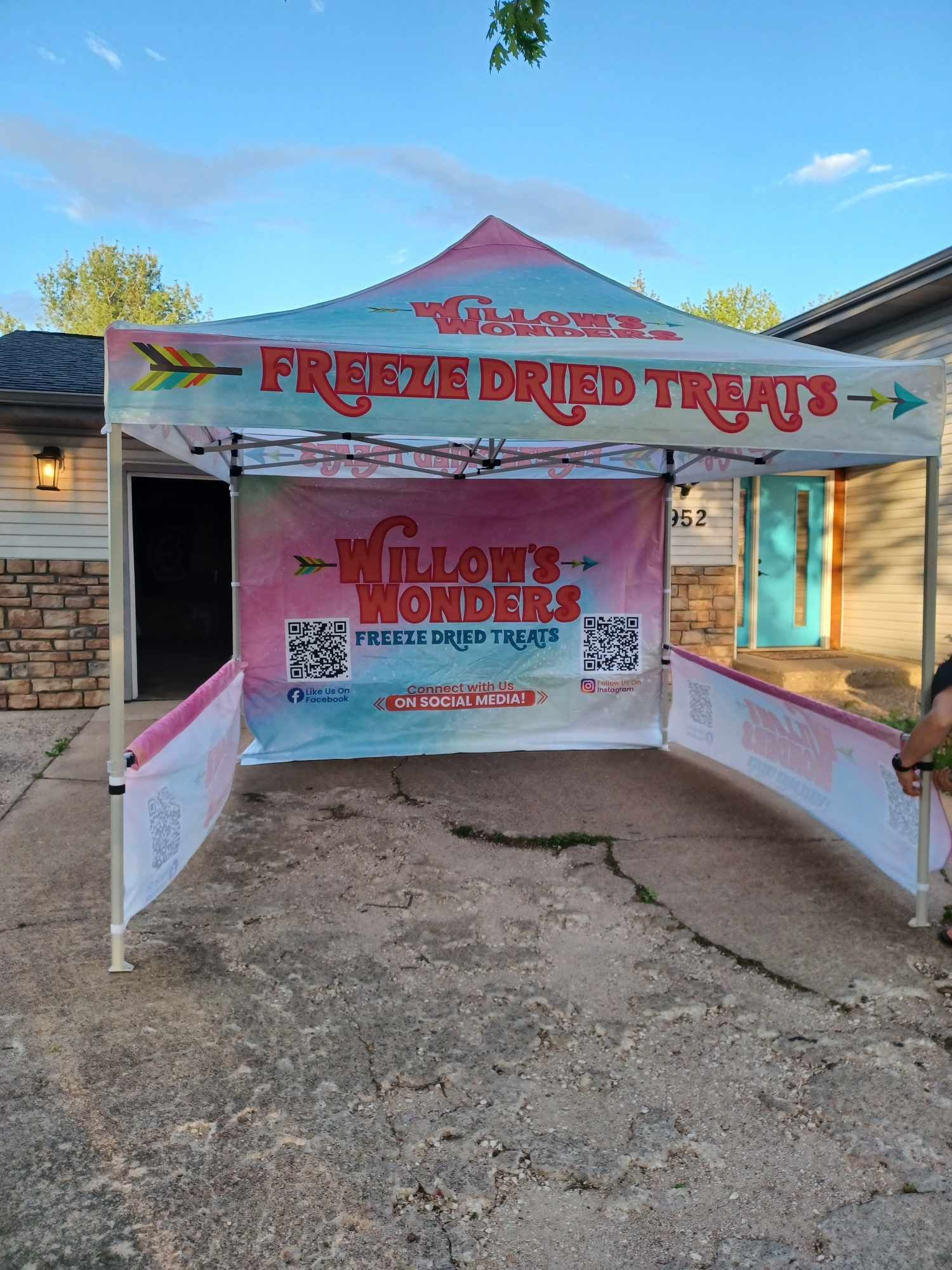 A freeze dried treats tent is sitting in front of a house.