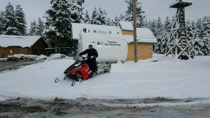 A man sitting on a red snowbike