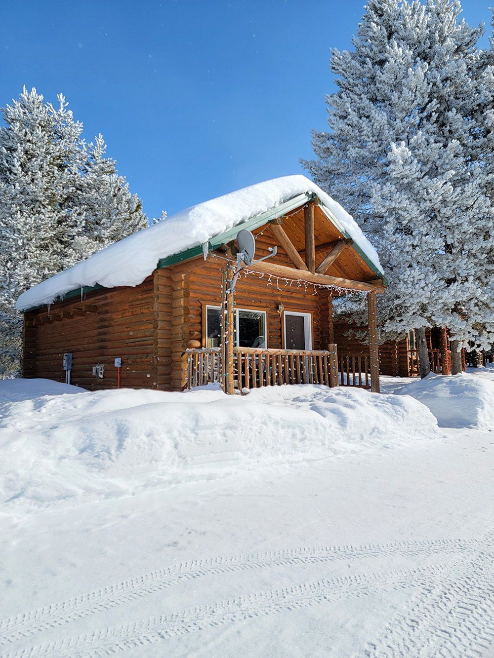 A cabin with a thick snow on the roof