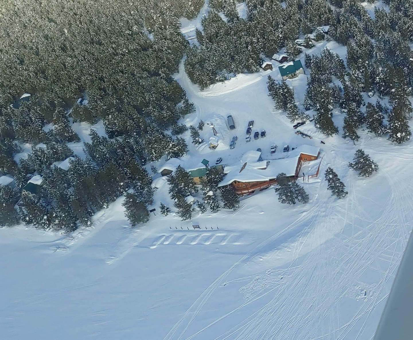Aerial view of Lakeside Lodge covered in snow
