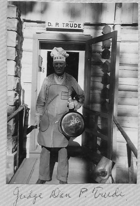 black and white man holding pot in doorway