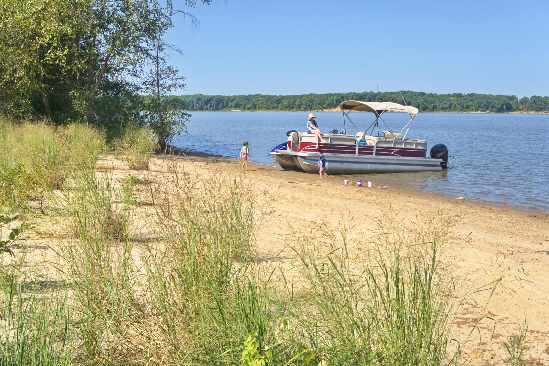 Pontoon boat docked on a shore