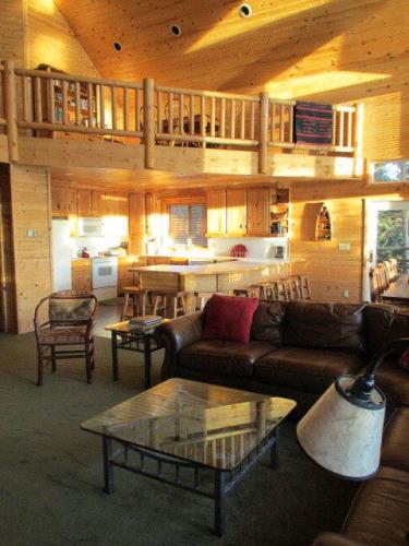 Living room with chairs, tables, and couch