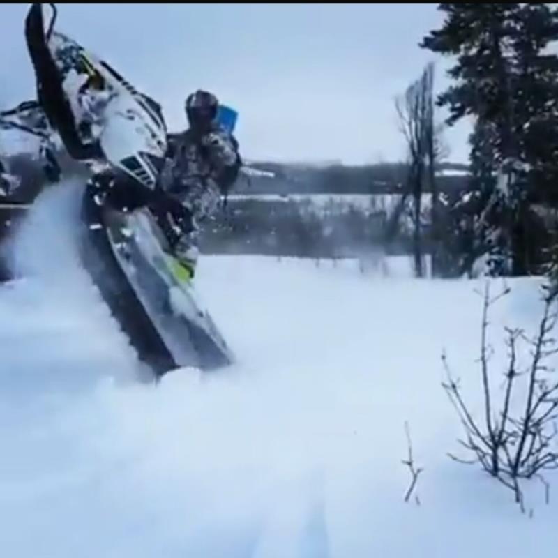 Snowmobile rider doing a stunt
