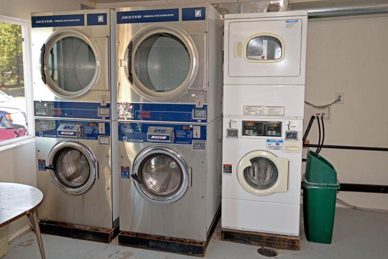 Piled up washing machines and driers