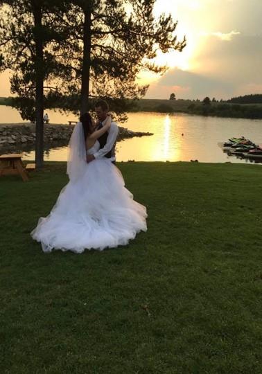 Bride and groom dancing on a sunset