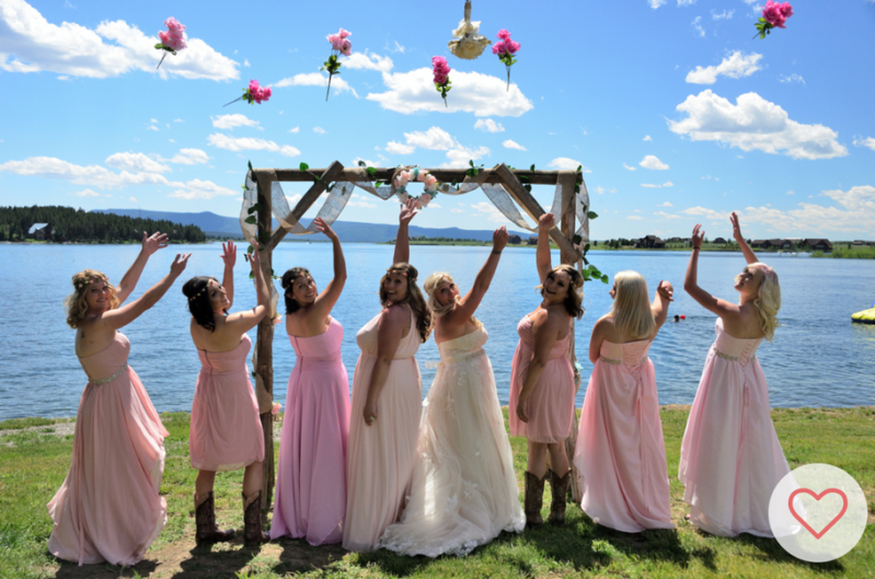 Bride and bridesmaid throwing their bouquets of flowers