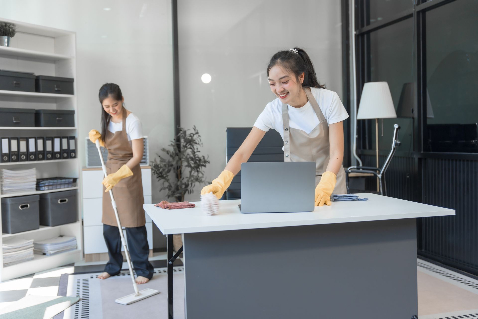 A woman is hugging another woman in a group of people sitting in chairs.