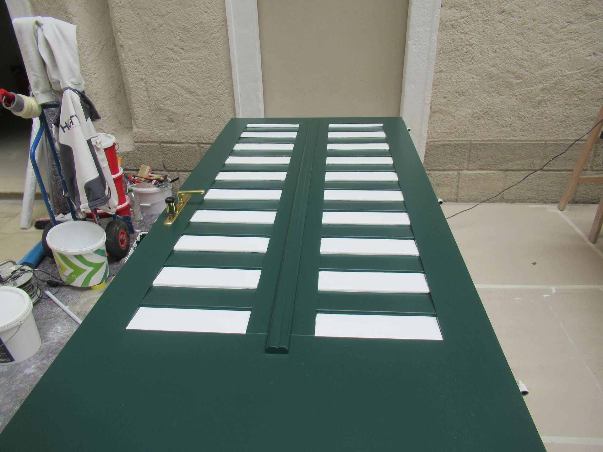 Eine weiße Tür steht auf einem Tisch vor einer Backsteinwand.