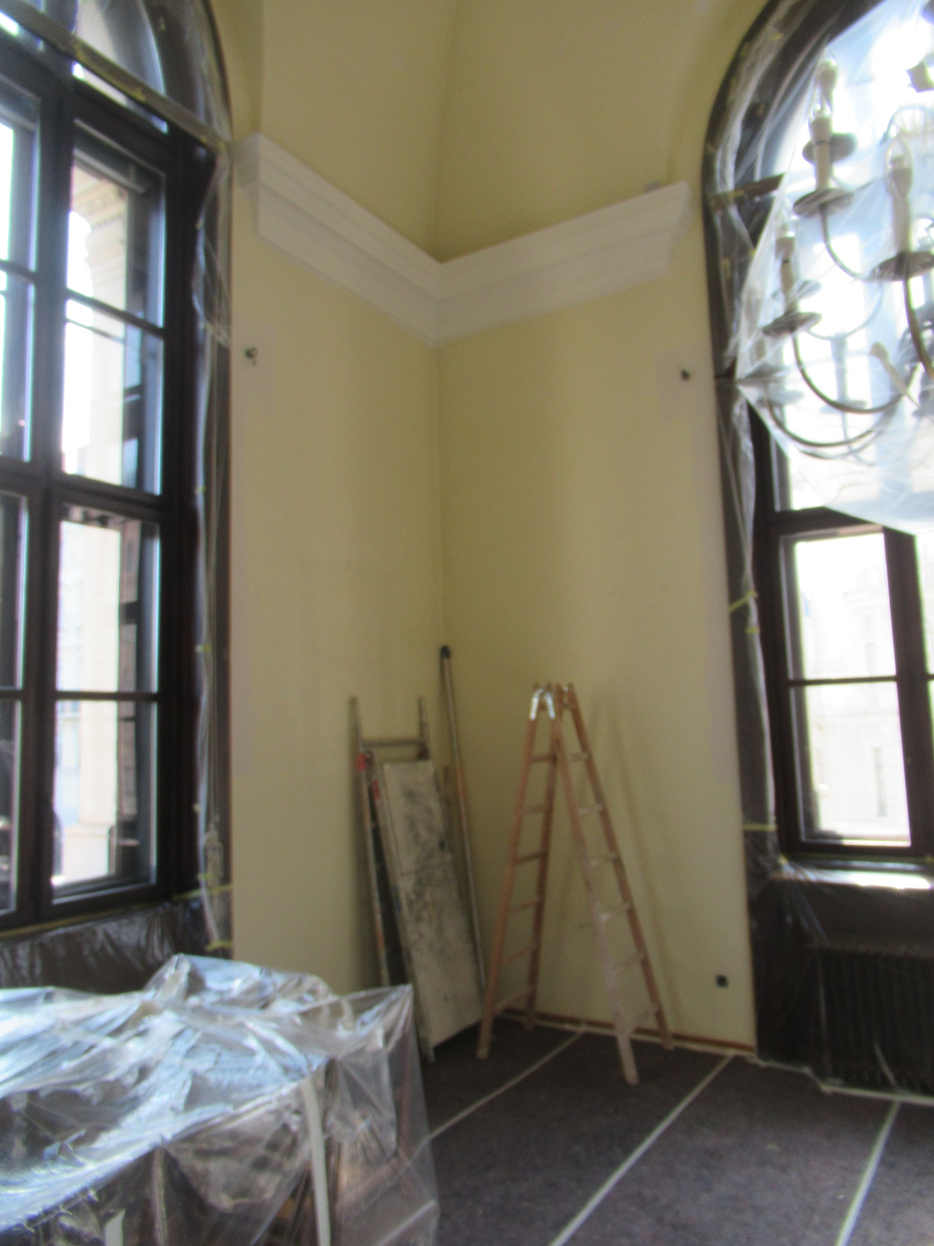 Ein Raum mit einer Leiter und einem Kronleuchter darin