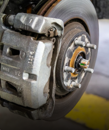 A close up of a brake caliper on a car wheel | Protech Auto Group Inc