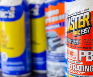 Several Cans of Faster Since 1957 Are Lined Up on a Table - Protech Auto Group Inc.