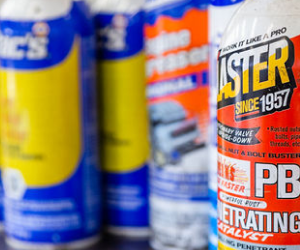 Several cans of faster since 1957 are lined up on a table | Protech Auto Group Inc