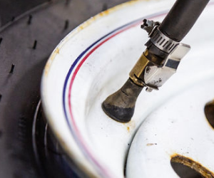 A close up of a tire with a hose attached to it | Protech Auto Group Inc