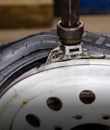 A close up of a tire being changed with a tool | Protech Auto Group Inc