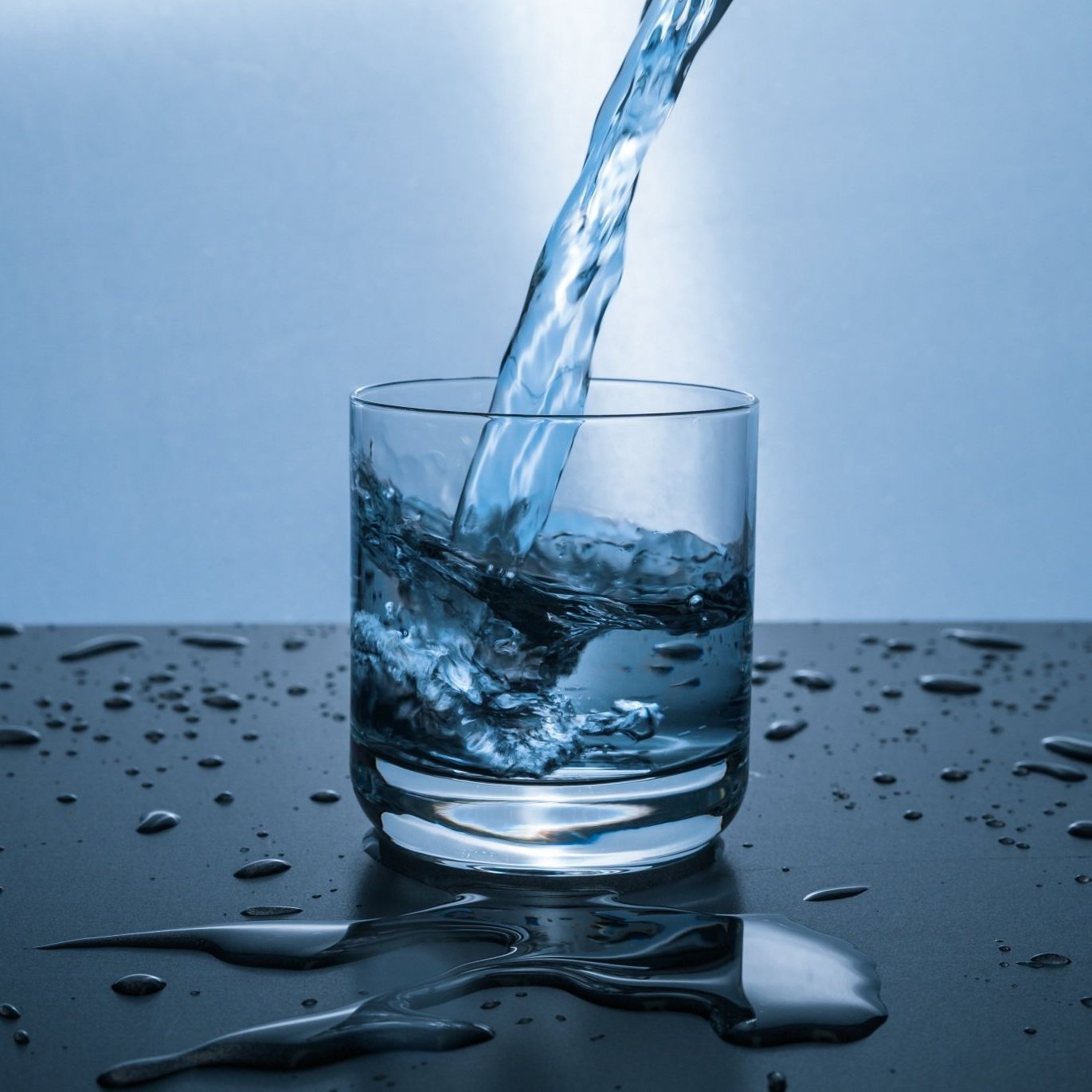 a glass of water is being poured into it