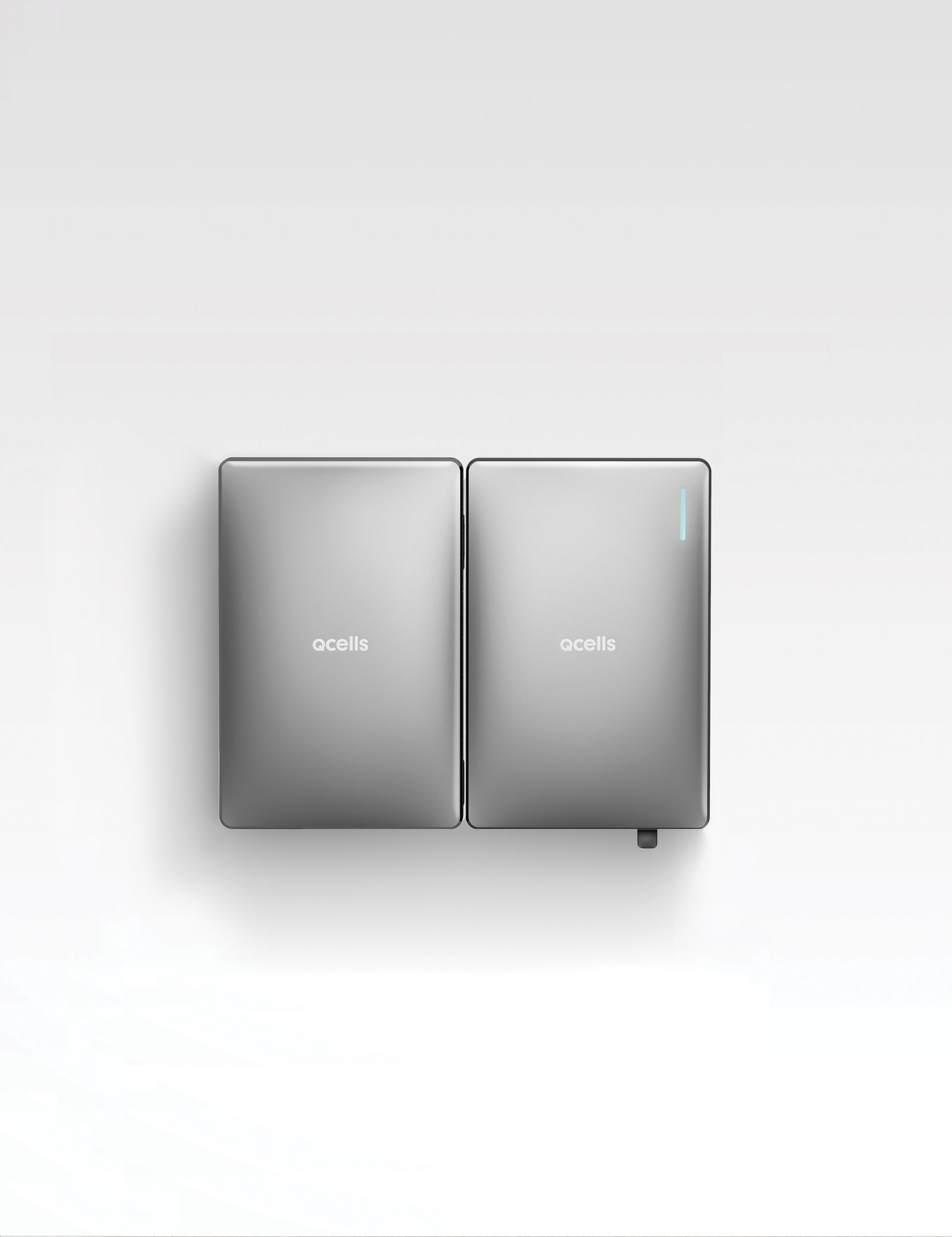 A pair of laptops sitting on top of each other on a white surface.