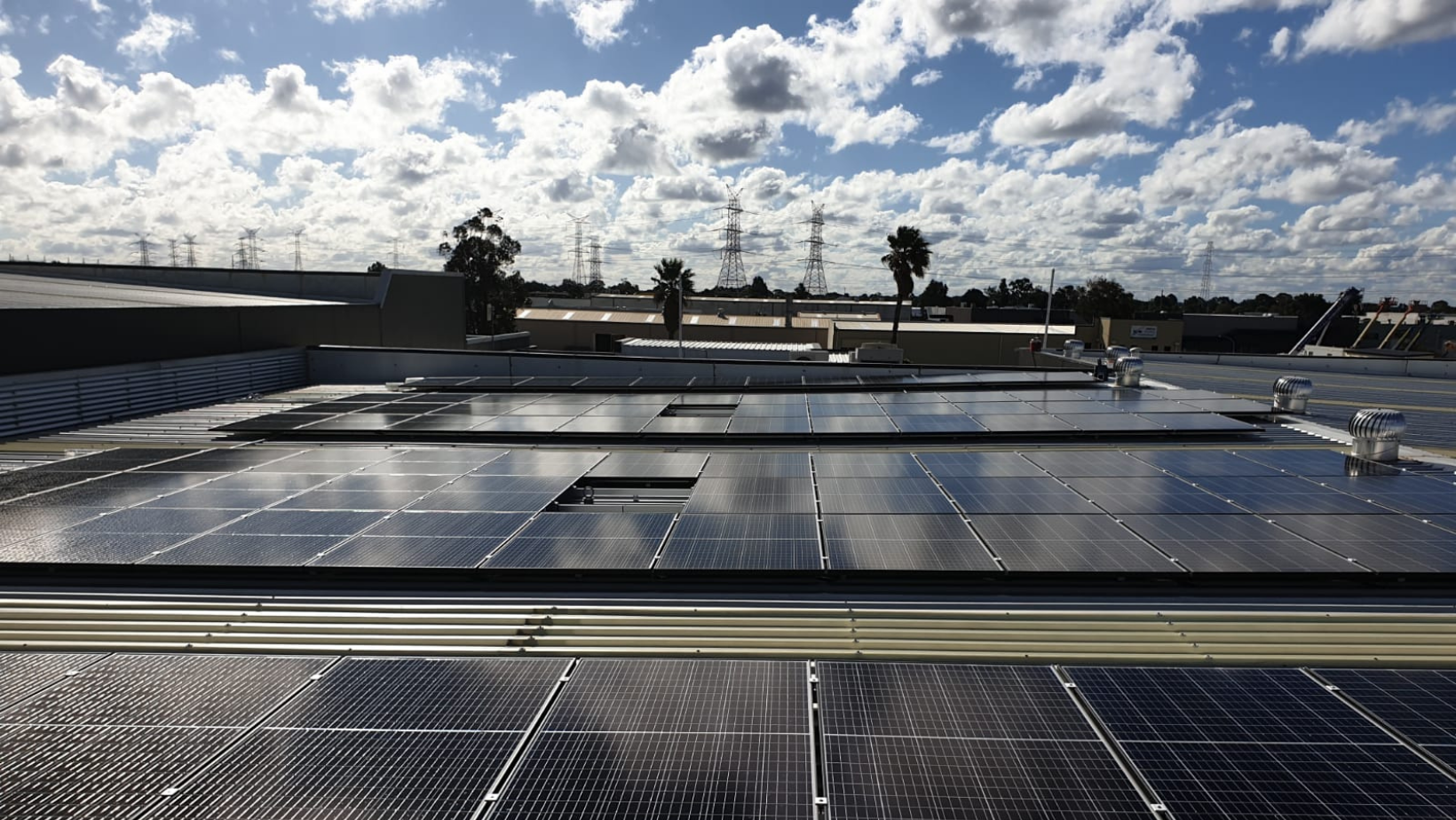 A row of solar panels on the roof of a building