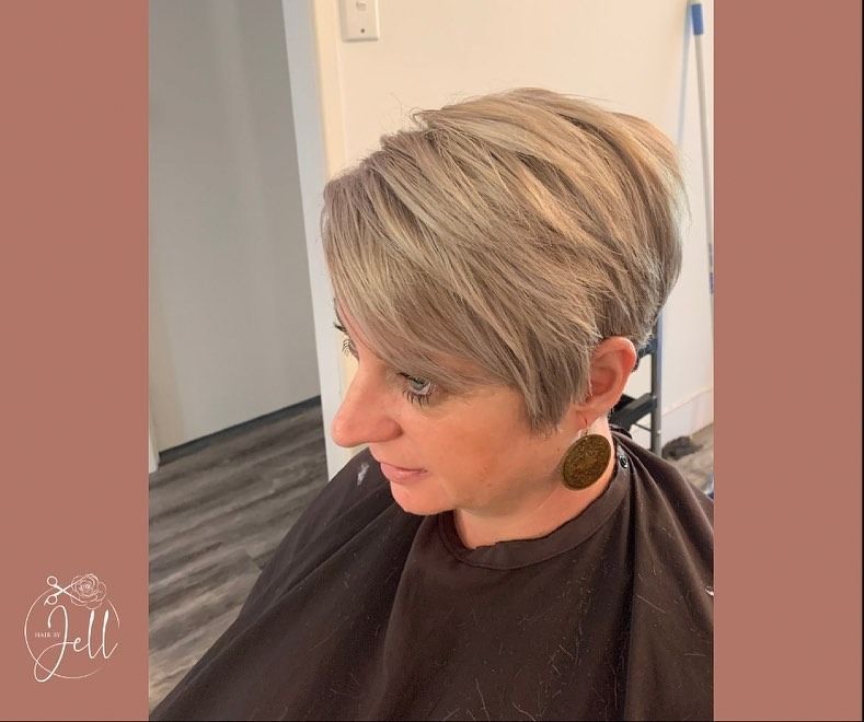A Woman is Getting Her Hair Cut in a Salon — Hair By Jell In Cannonvale, QLD