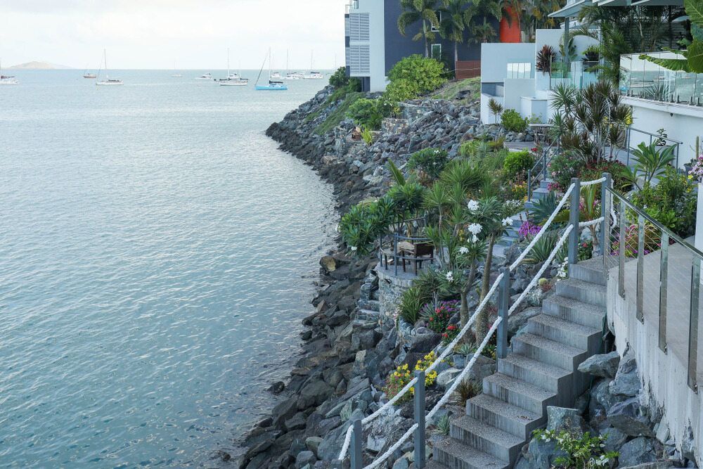 A Staircase Leading Up to a Cliff Overlooking the Ocean — Hair By Jell In Cannonvale, QLD