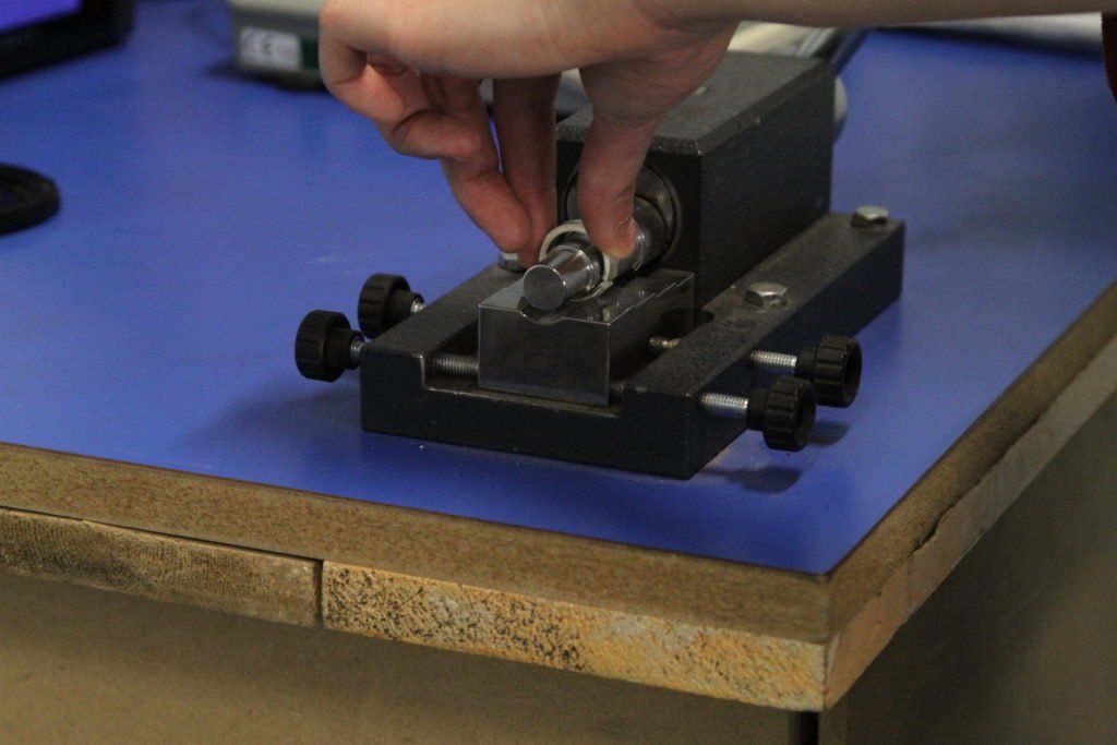 Using the ring bending tool to turn up a ring.