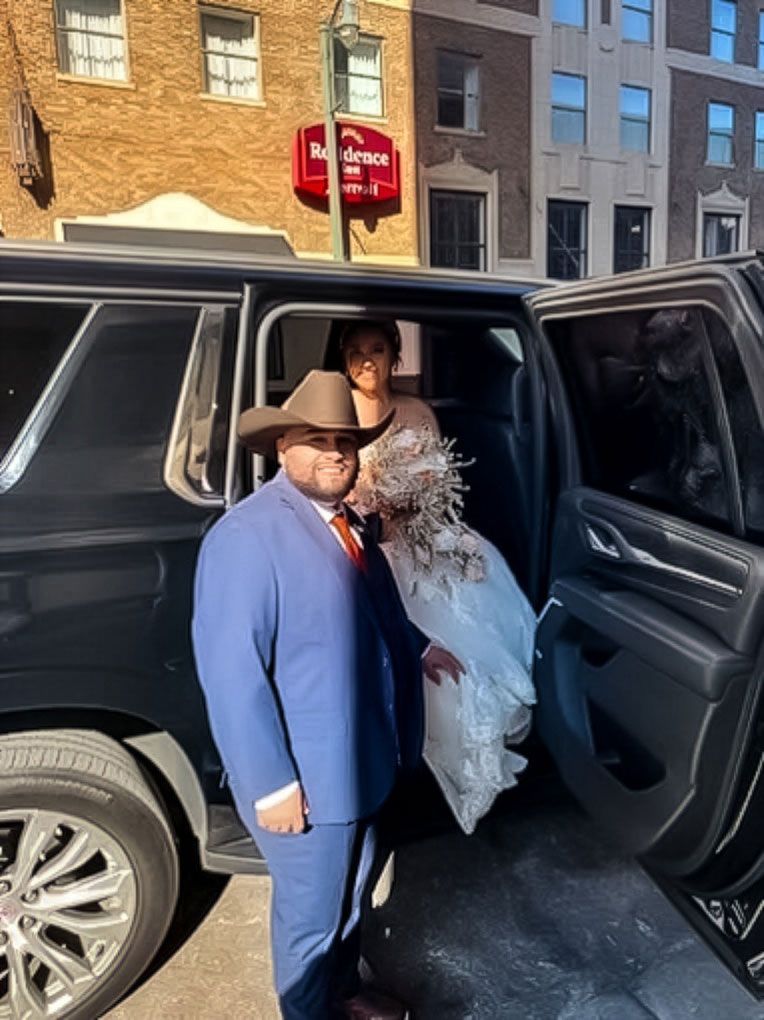 Group of professionals walking outside a modern building, holding coffee cups, and engaged in conversation.