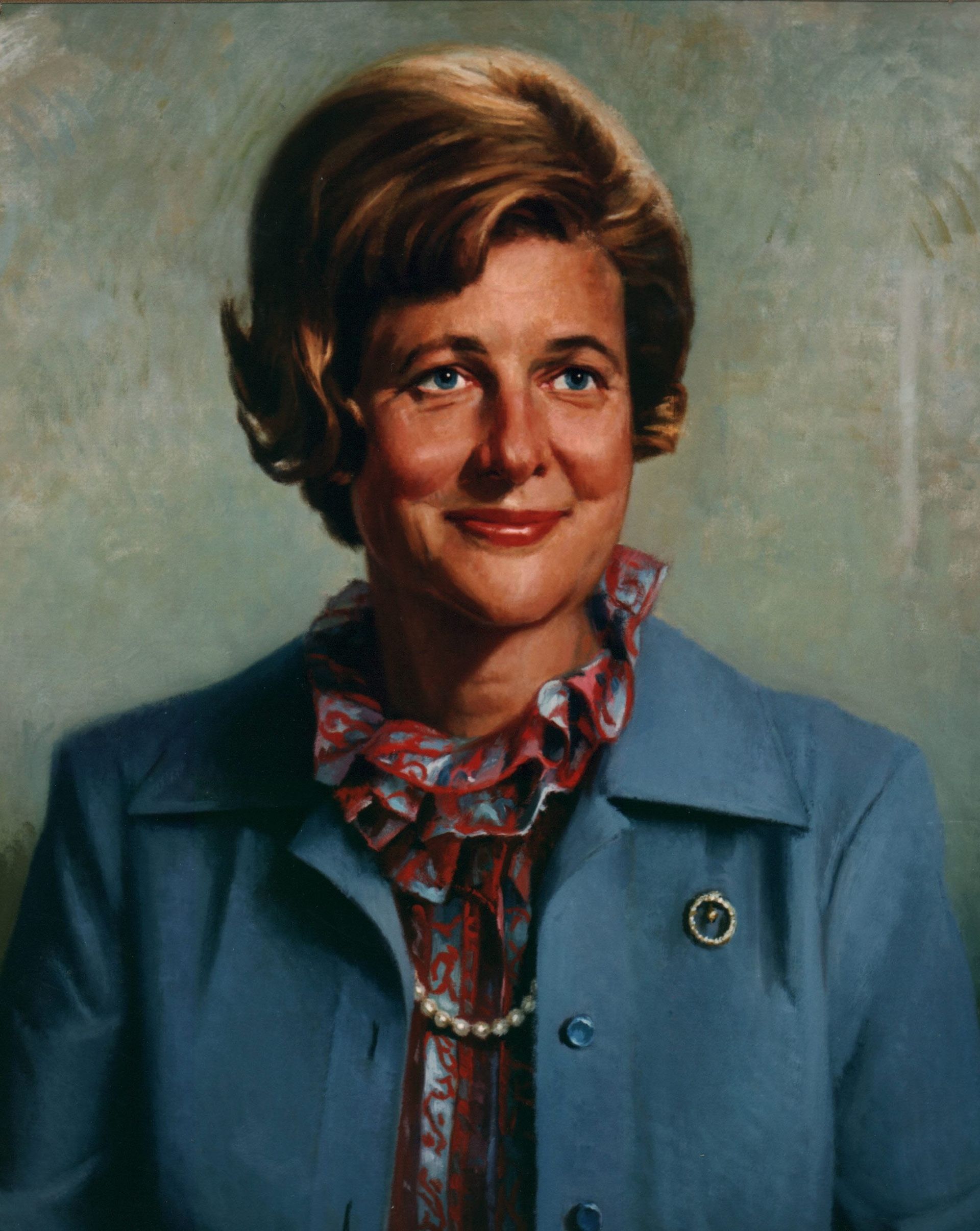 A portrait of a woman in a blue jacket and scarf
