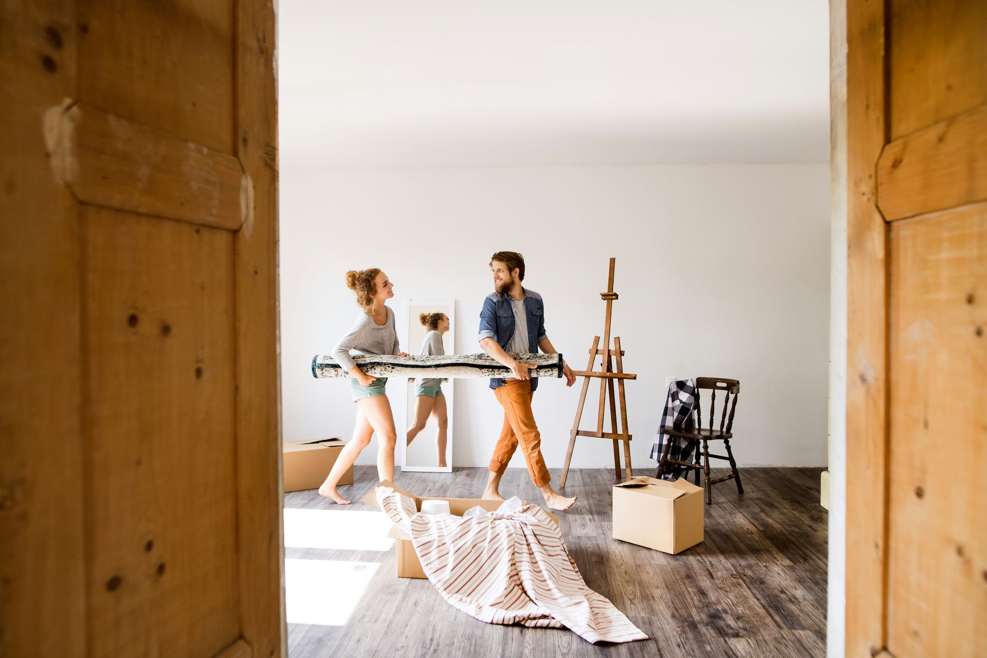 A man and a woman are moving into a new home.