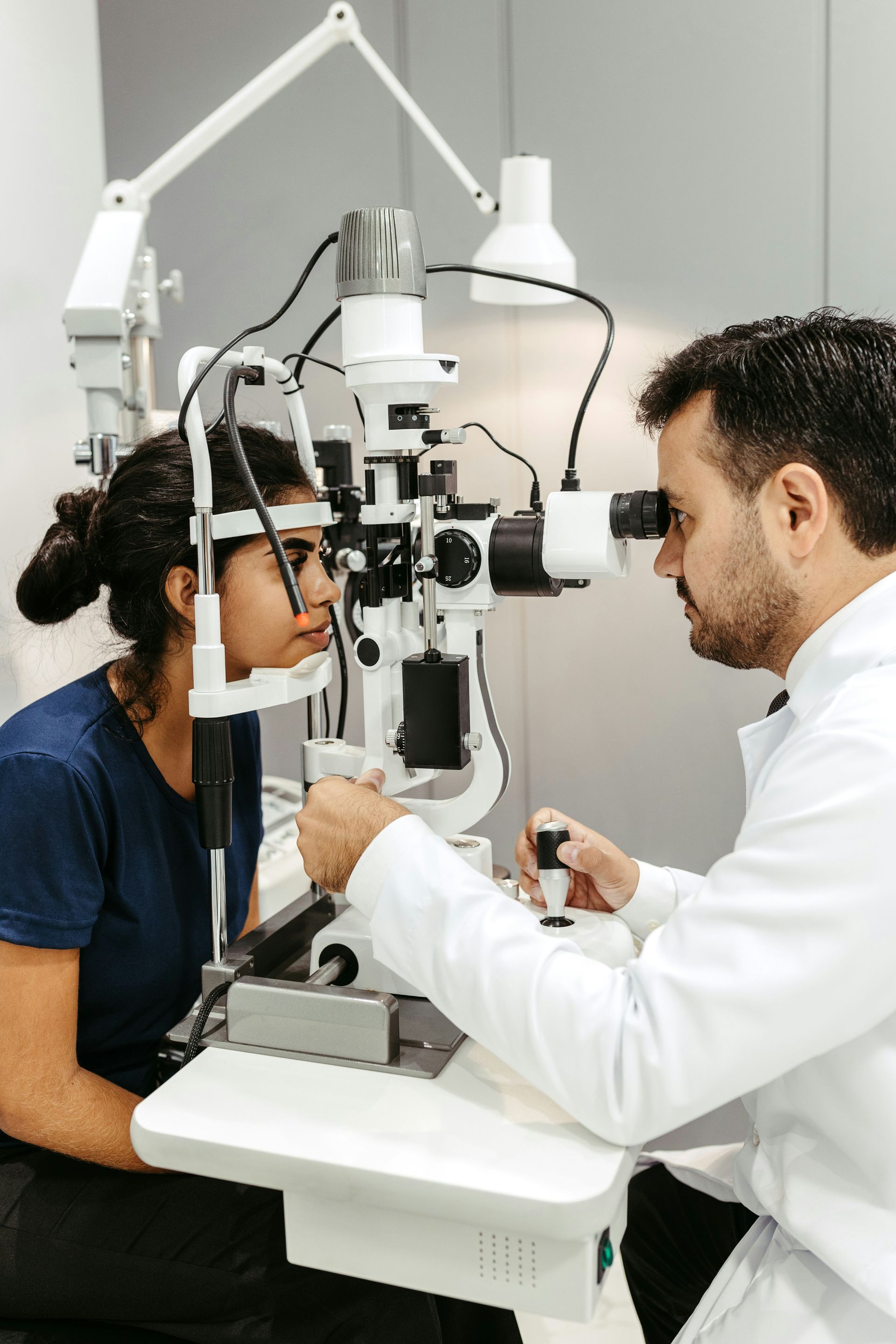 A woman is getting her eyes examined by an ophthalmologist.