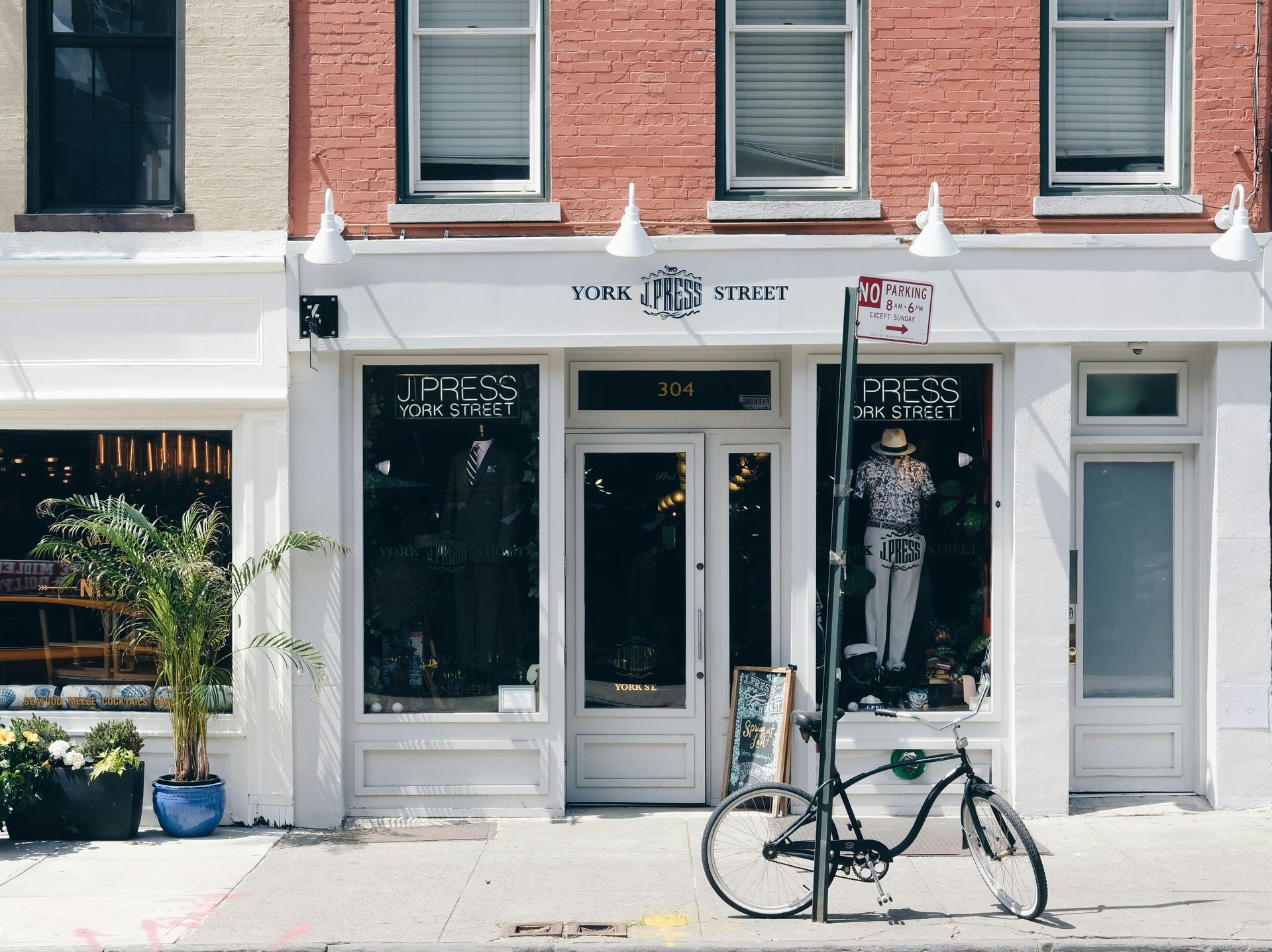 A bicycle is parked in front of a store.