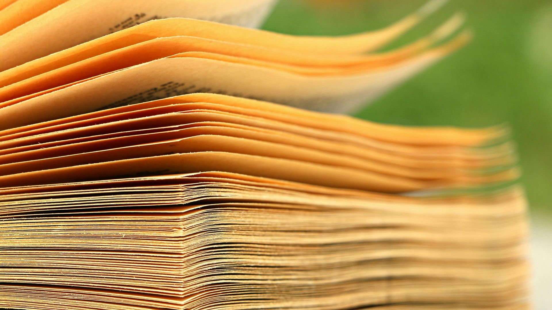A stack of papers is blowing in motion