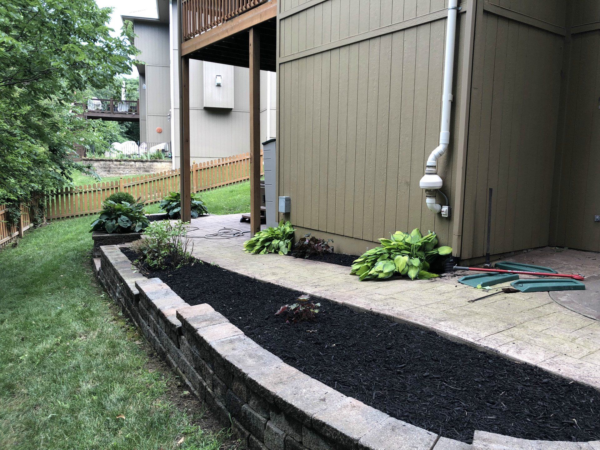 A house with a fence and a walkway in front of it.