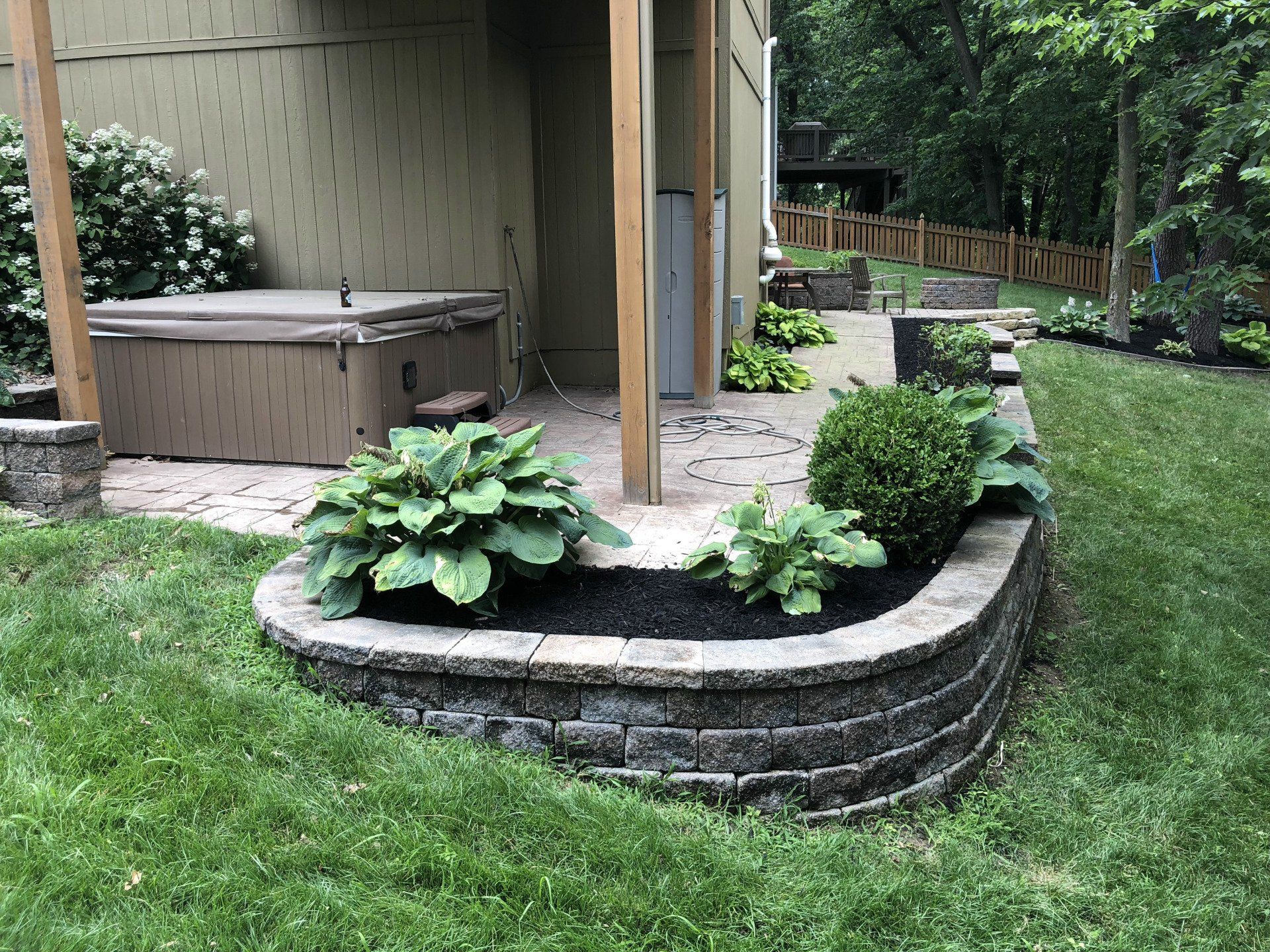 There is a hot tub in the backyard of a house.