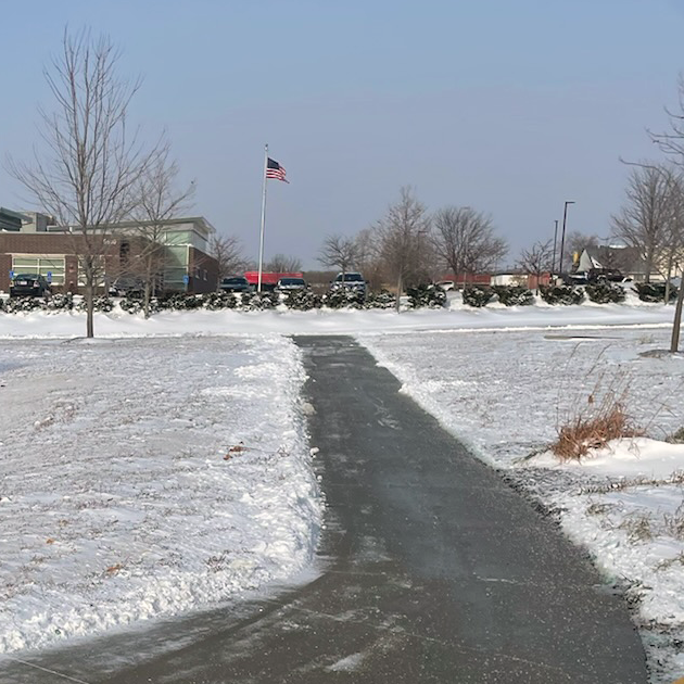 a snowy park with an american flag in the background