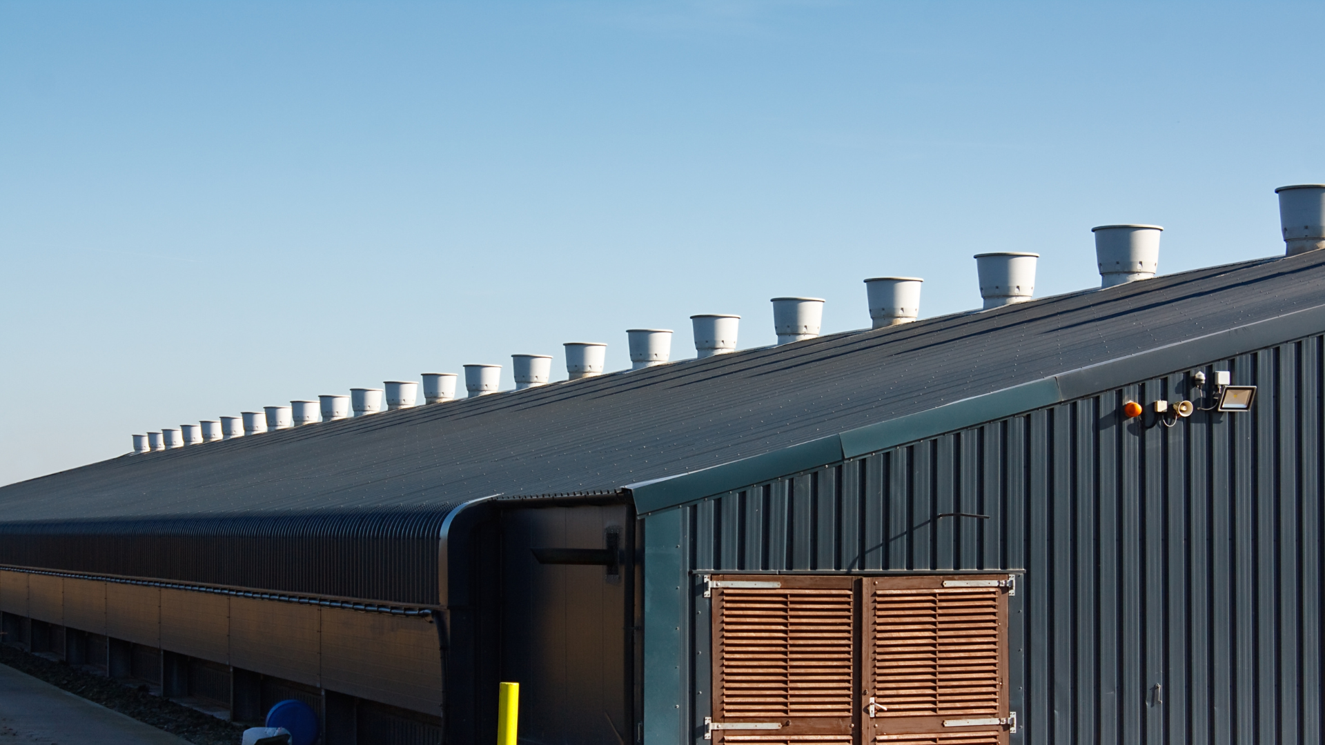 A large building with a lot of chimneys on the roof.