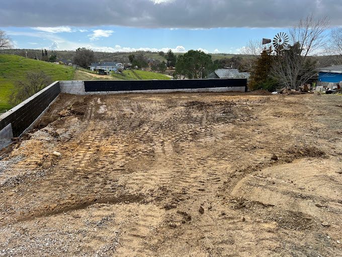 A large pile of dirt is sitting on top of a dirt field.