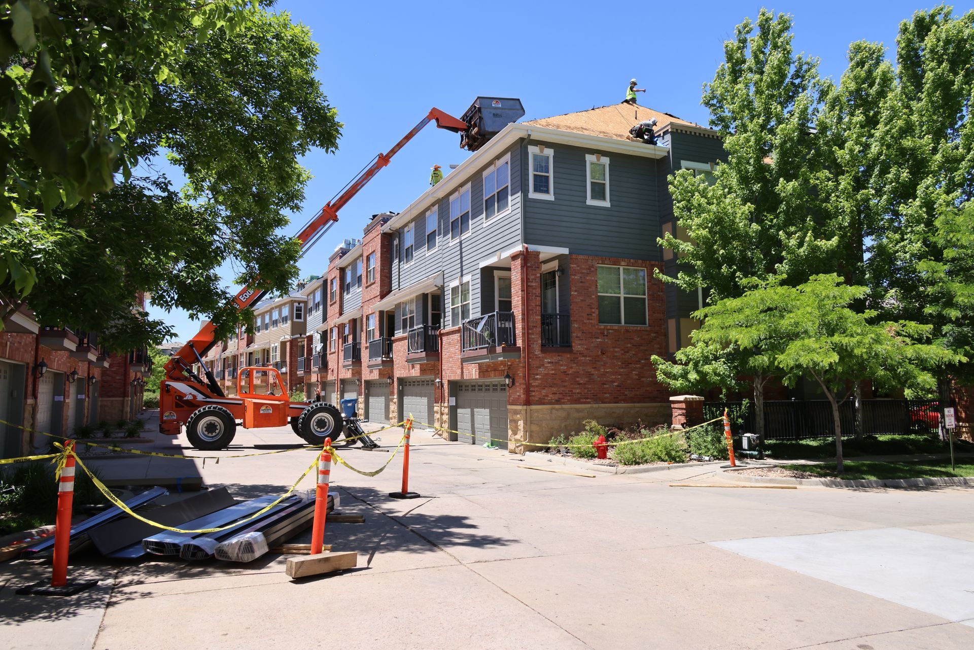 Reroofing a condominium complex in an HOA in Southern Colorado, using a lift for three stories