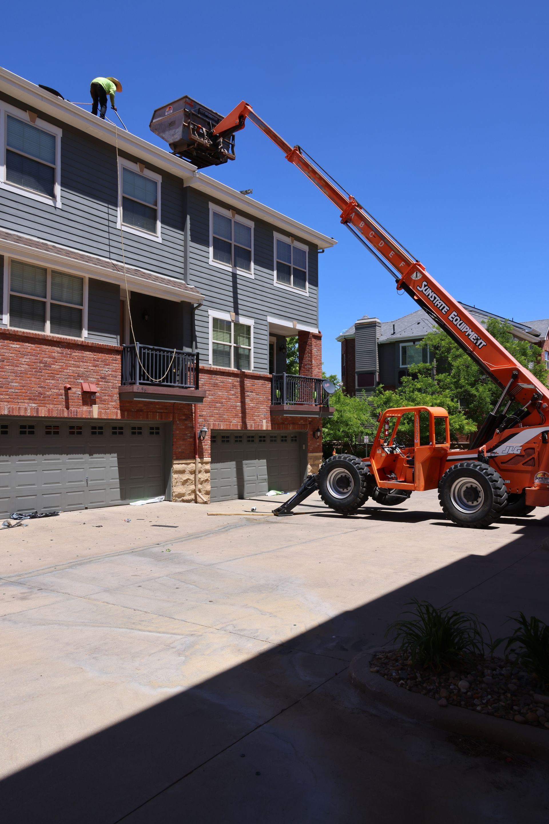 Reroofing a condominium complex in an HOA in Southern Colorado, using a lift for three stories