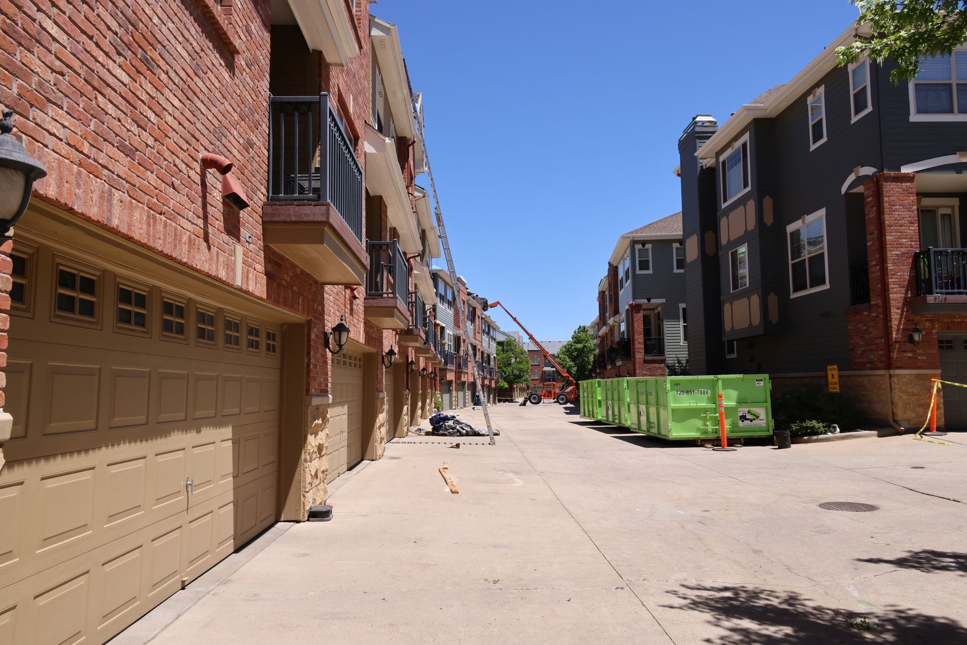 Reroofing apartments in an HOA in Southern Colorado, using a lift for three stories