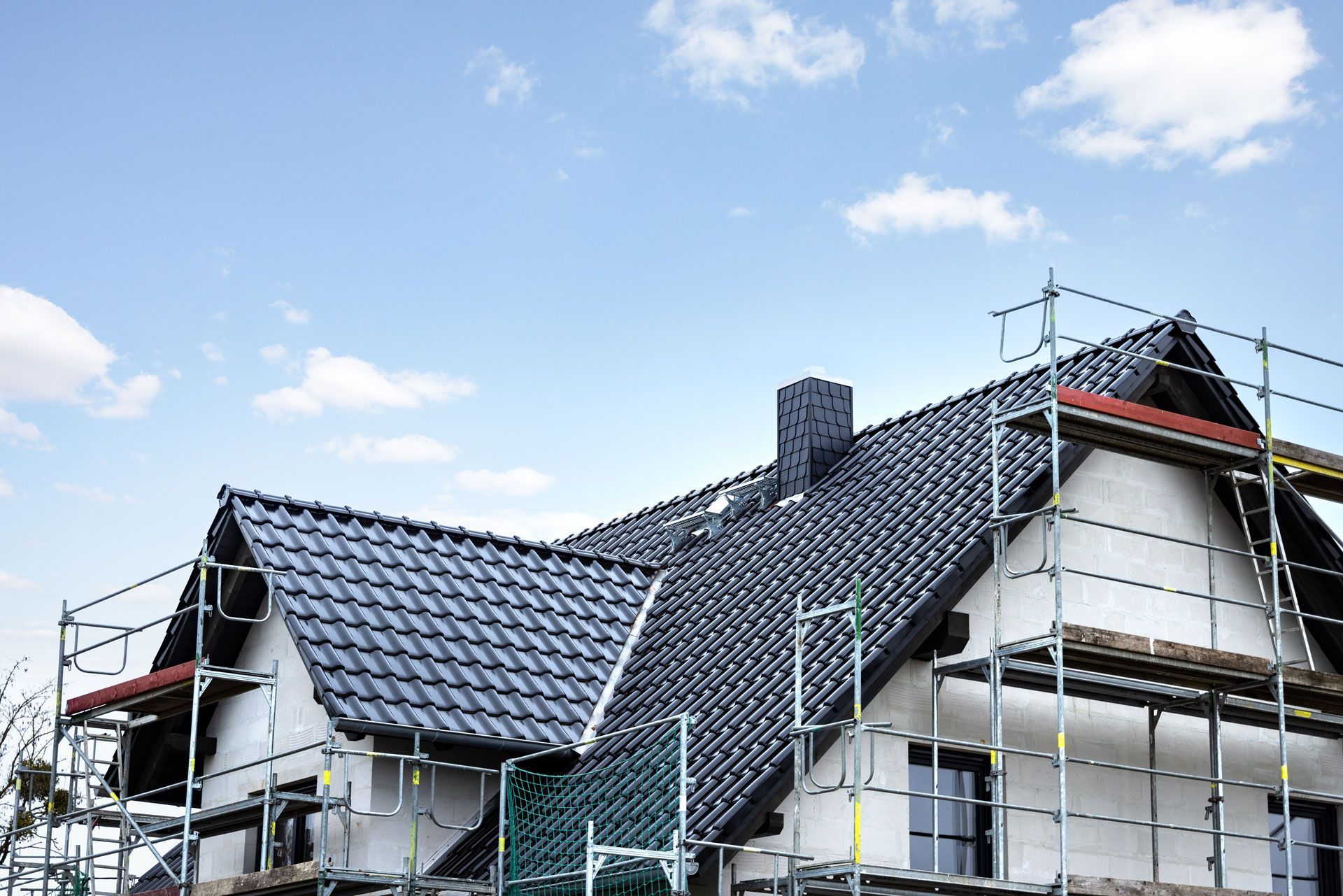 A house is being built with scaffolding around it.