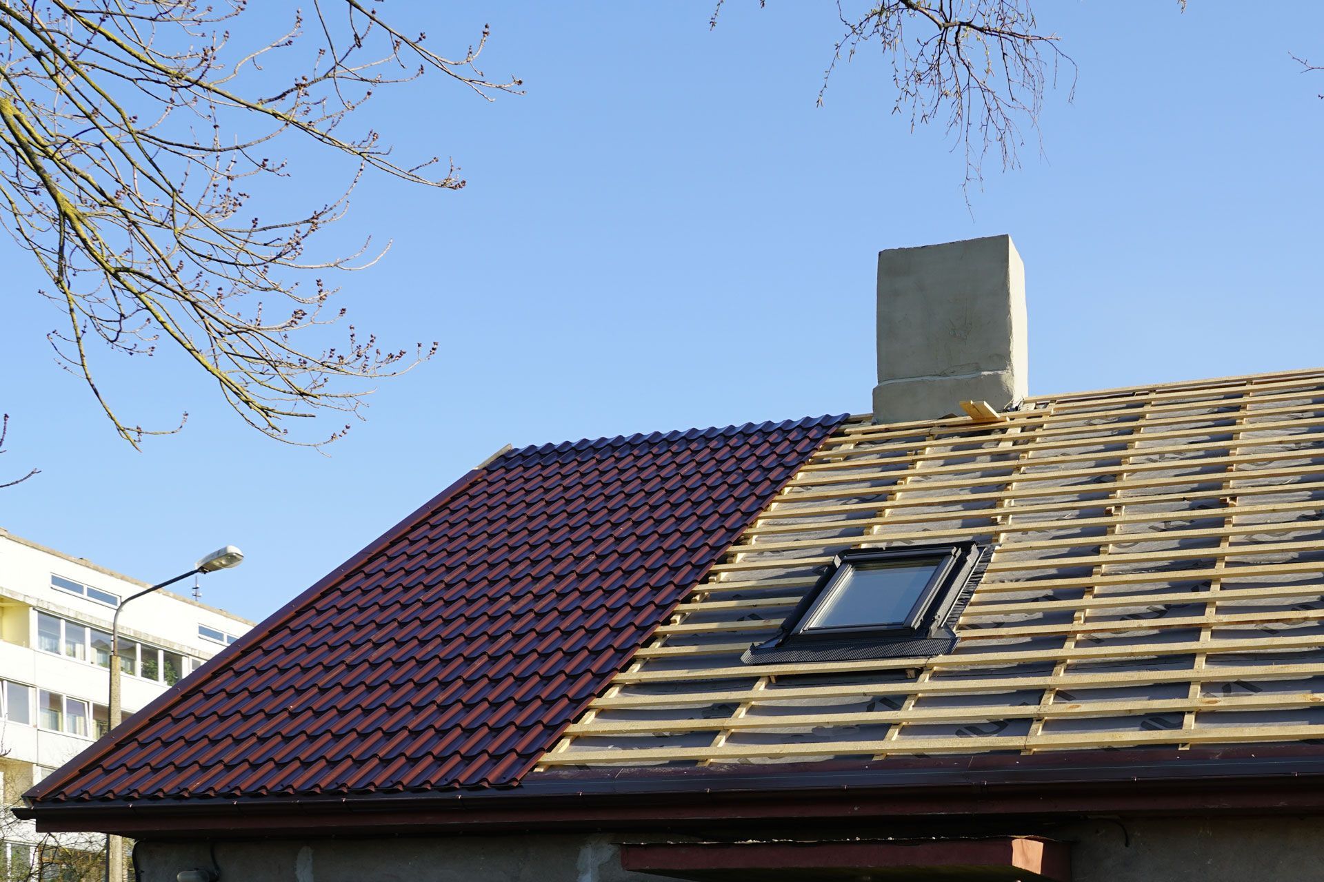 A roof with a skylight and a chimney on it