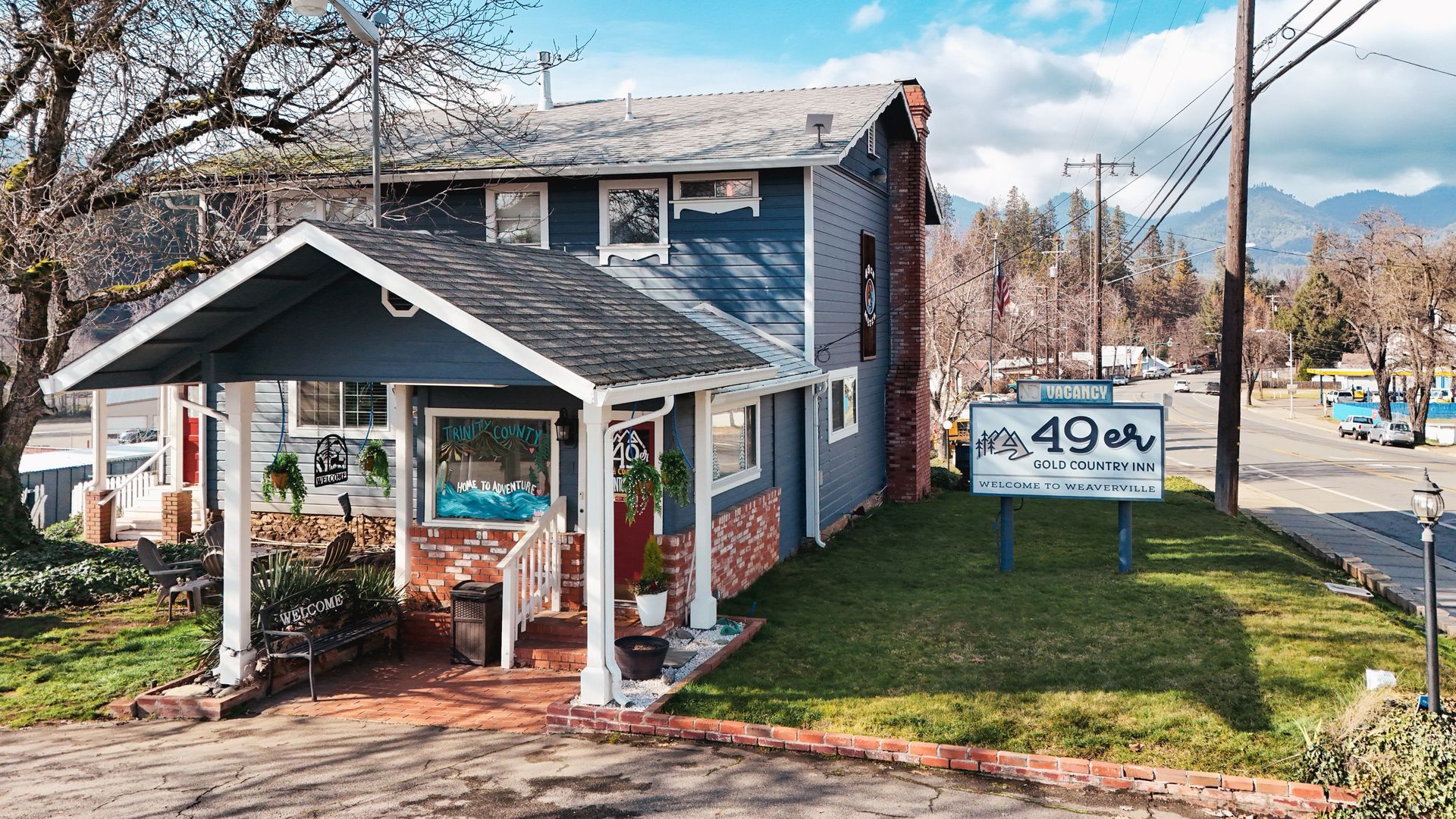 Blue and brick building with a sign that reads 