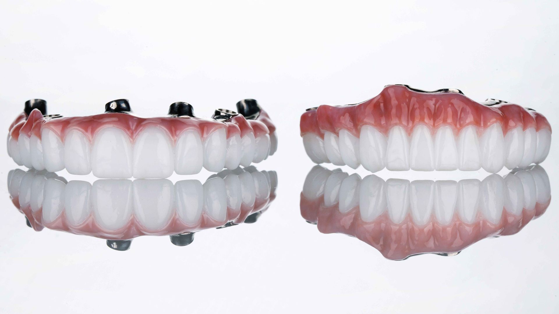 A close up of a denture and a full denture on a white surface.