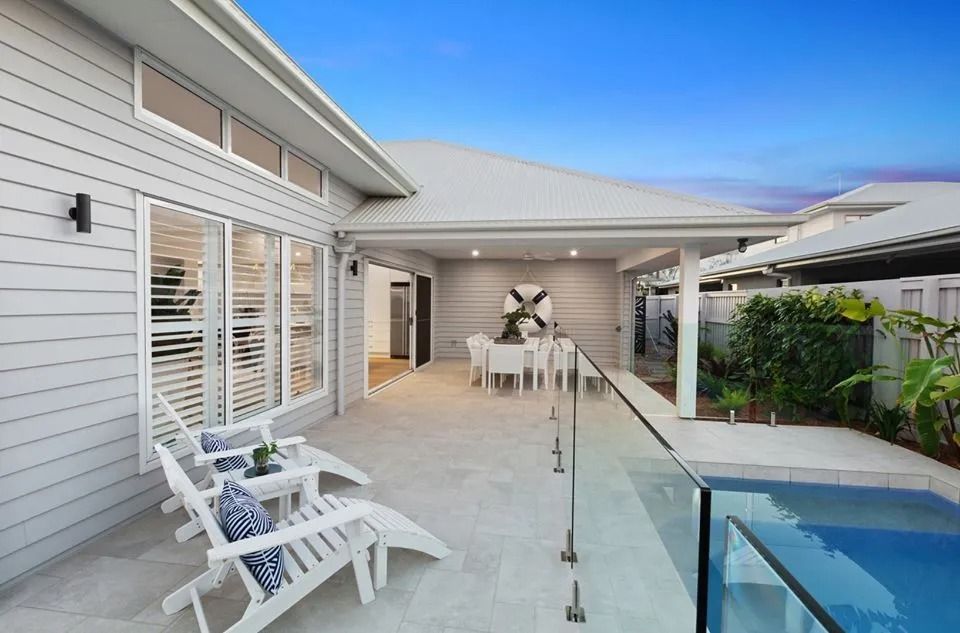 There Is A Swimming Pool In The Backyard Of A House  — Norm Evans Floors Pty Ltd in Kunda Park, QLD