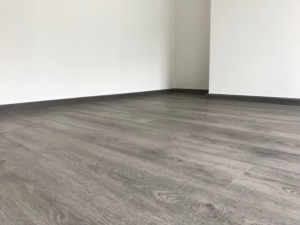 An Empty Room With A Wooden Floor And White Walls — Norm Evans Floors Pty Ltd in Gympie, QLD