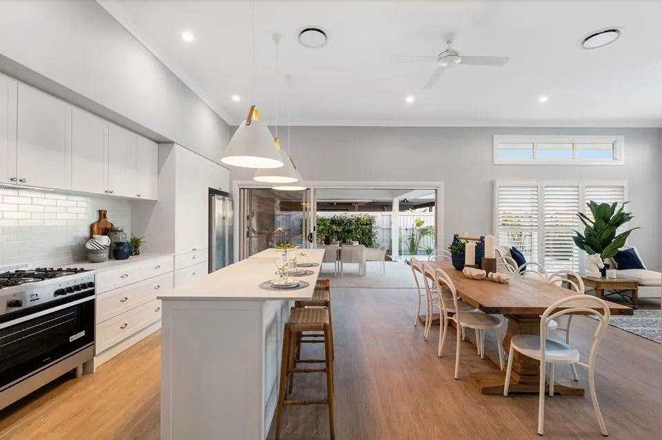 A Kitchen With A Long Island And A Dining Table  — Norm Evans Floors Pty Ltd in Kunda Park, QLD