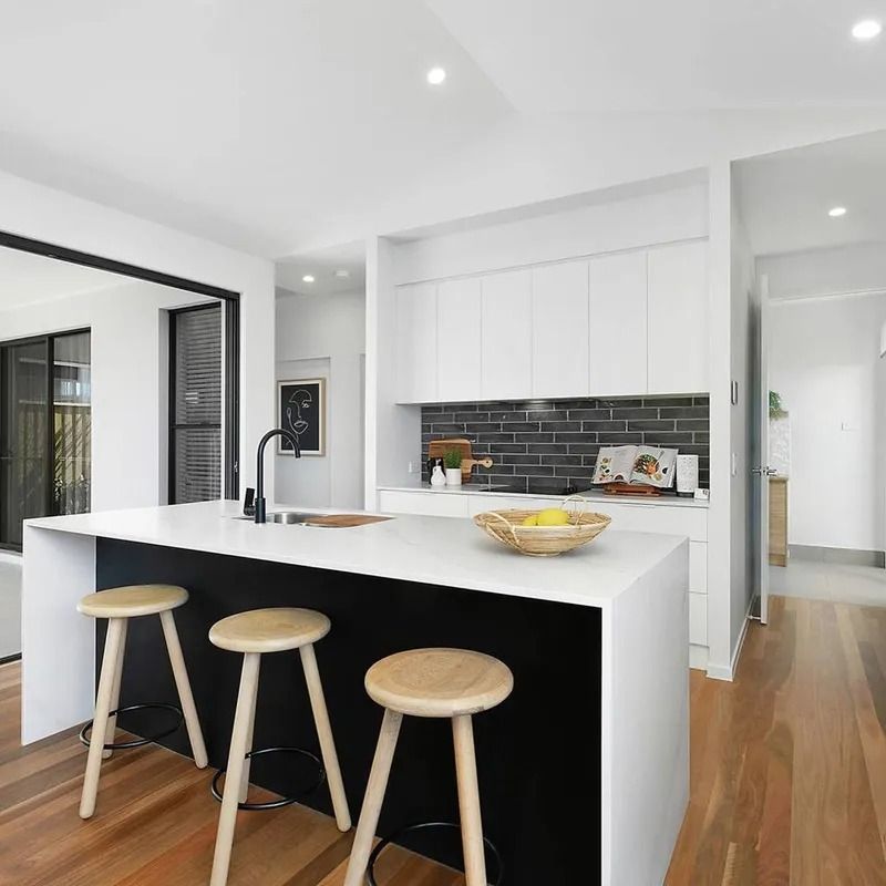 A Kitchen With A Large Island And Three Stools  — Norm Evans Floors Pty Ltd in Kunda Park, QLD